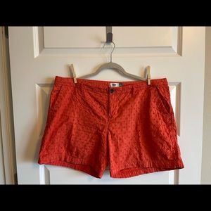 Orange eyelet shorts.